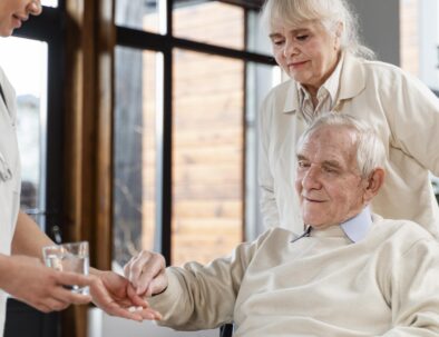 senior living facility nurse assisting resident with medication