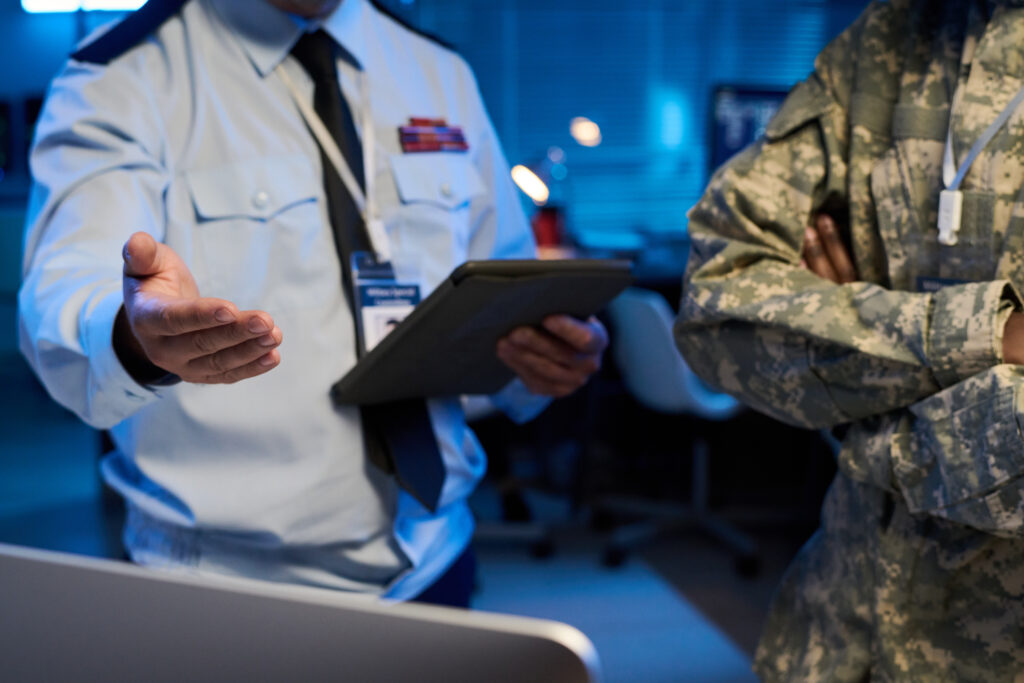 Team reviewing CMMC 2.0 and NIST SP 800-171 compliance requirements during a DoD cybersecurity readiness meeting with Centuric